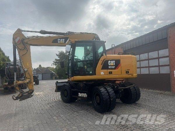 CAT M318F Pelle sur pneus