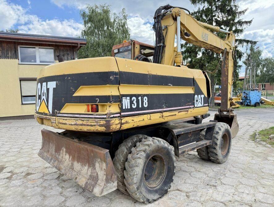 CAT M318 Pelle sur pneus
