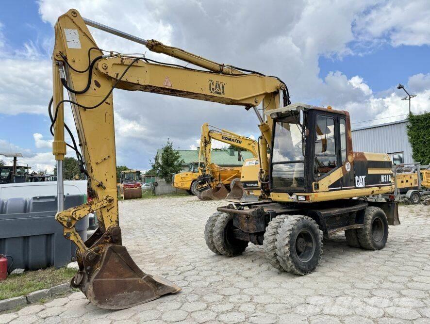 CAT M318 Pelle sur pneus